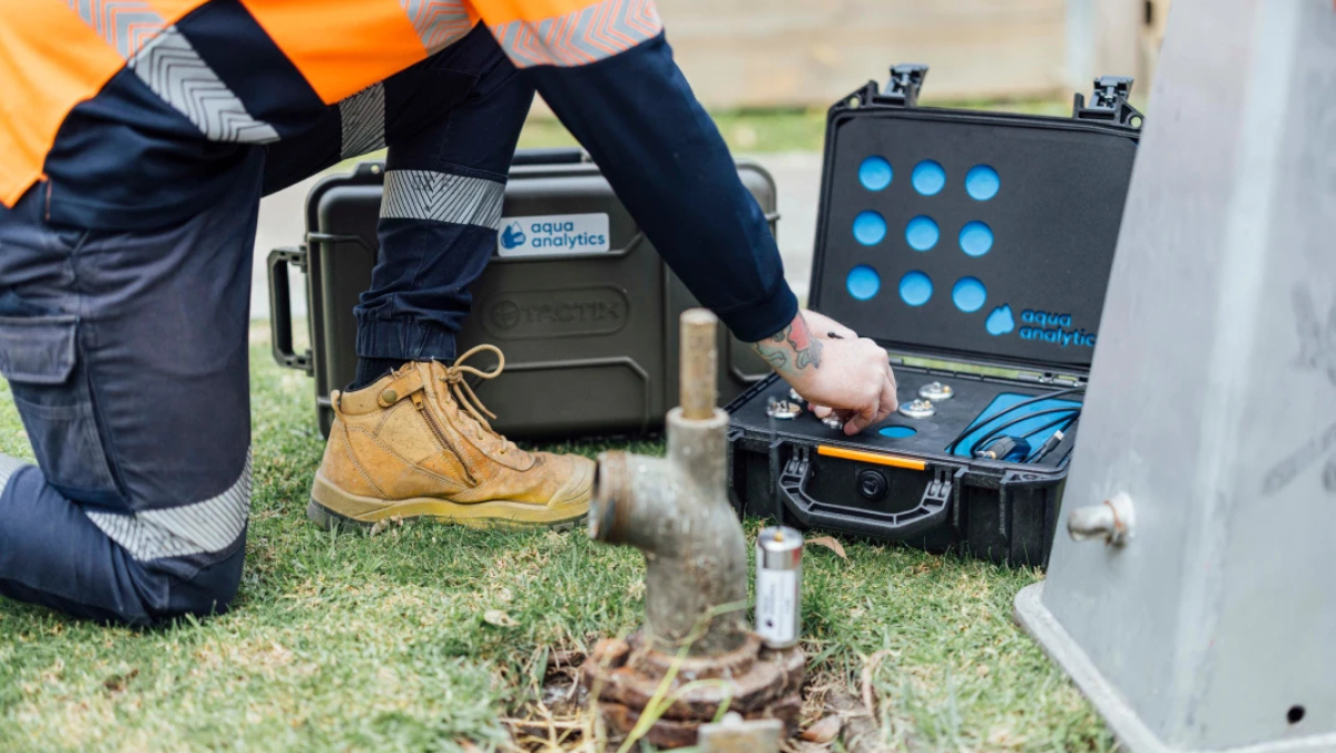 Technician using smart water analysis tools for leak detection in Australia