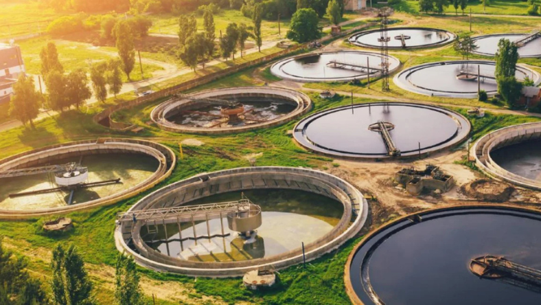 Circular water treatment tanks at a wastewater treatment facility viewed from above